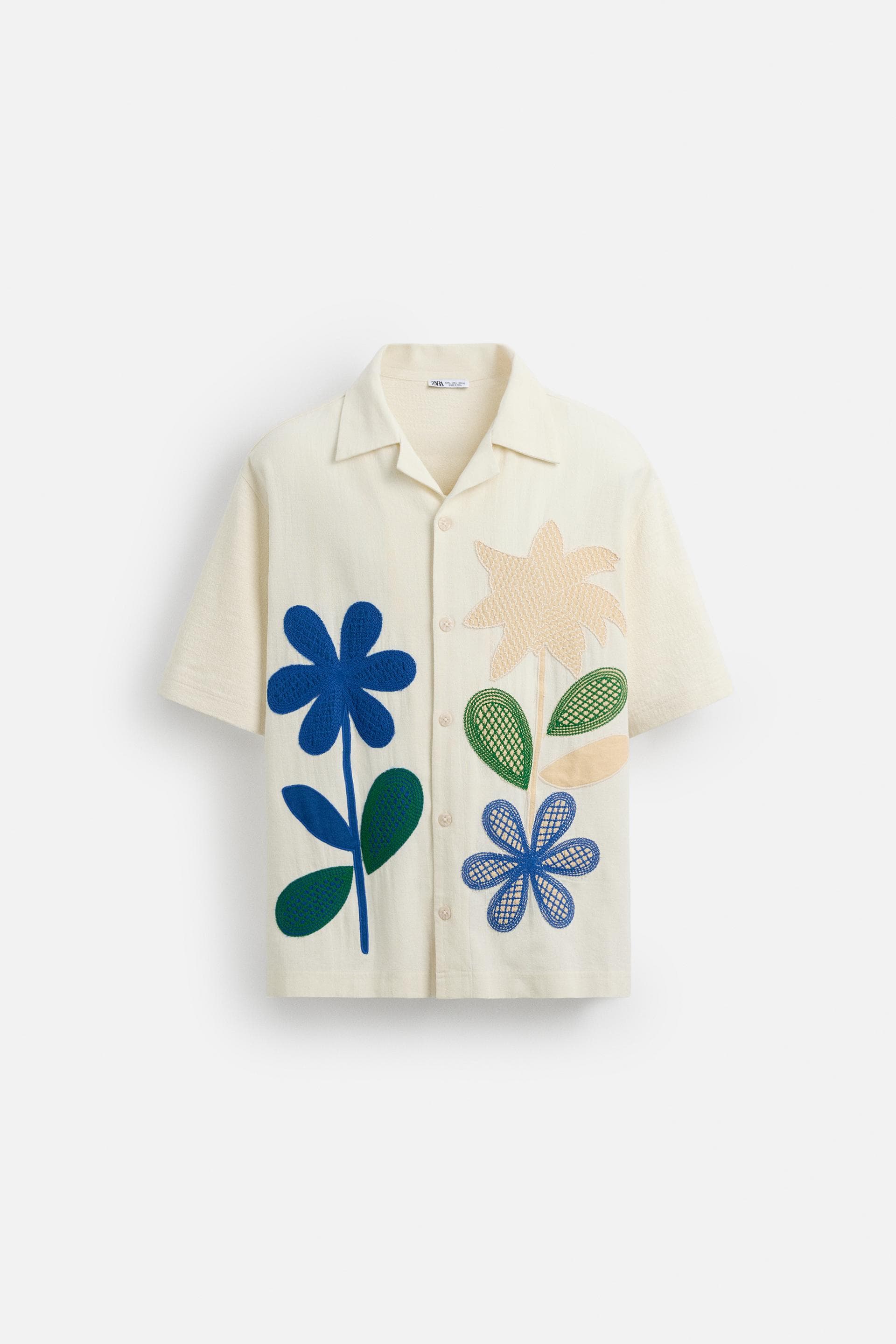 Insulated bottle with white base and black snap lid.